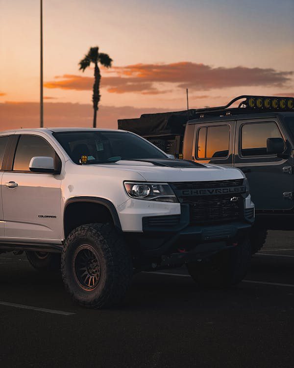 modern white chevrolet truck car at sunset