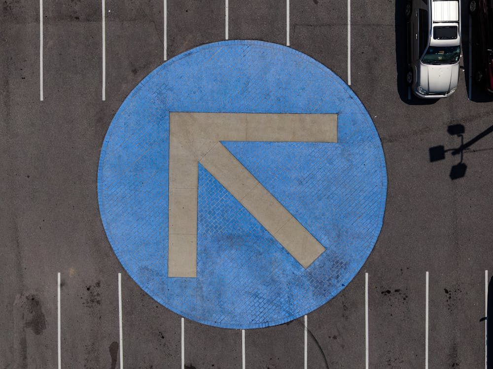 Well-marked parking lot with visible striping and directional arrow for smooth traffic flow