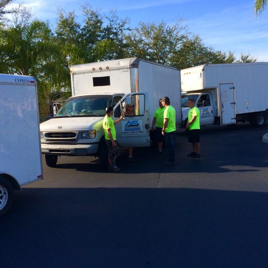Asphalt Sealers van with crew preparing for asphalt services in Sarasota