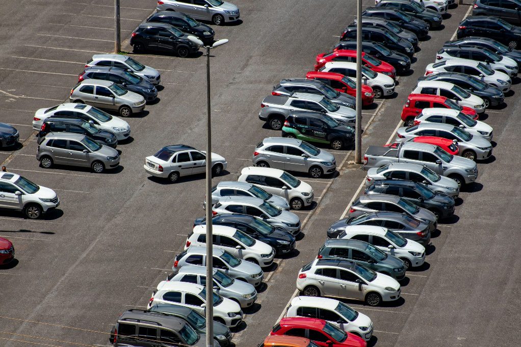 Parking lot with faded and worn line markings.