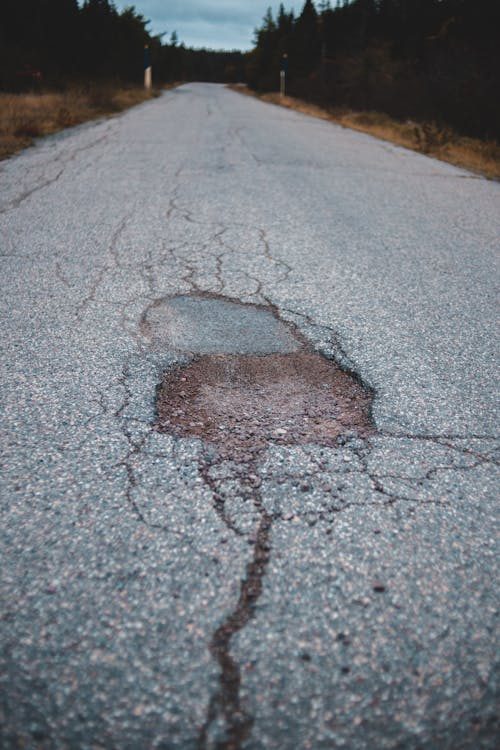 A pothole on an asphalt road