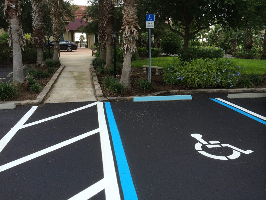 Parking lot with wheel stops, disabled parking signage, and security features