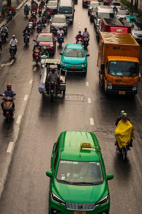 busy urban street with motor bikes and vehicles