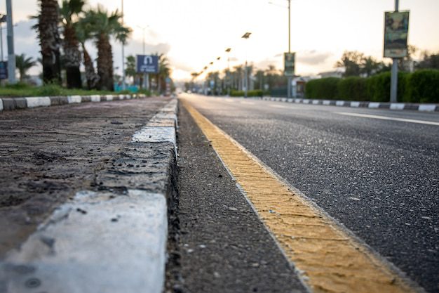 Asphalt road with visible wear, in need of sealcoating for protection and longevity.