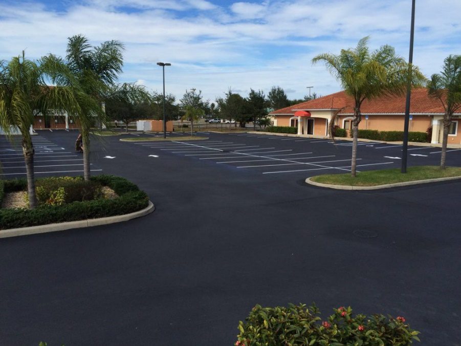 Freshly sealcoated pavement with a smooth black finish that protects the asphalt surface