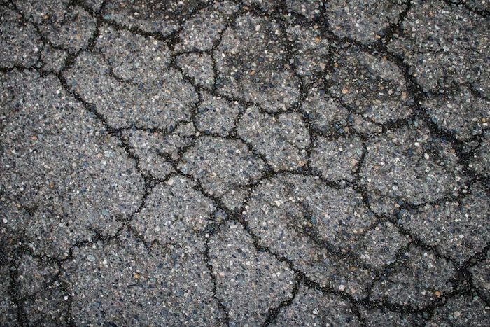 Cracked asphalt on the ground.