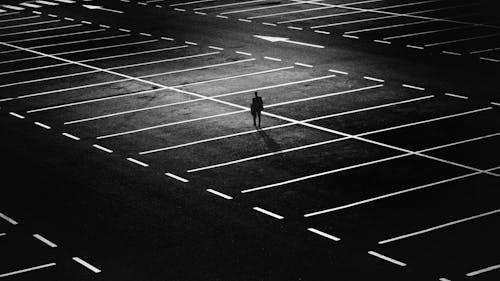 Parking lot at night with bright white striping providing visibility and organization for vehicles