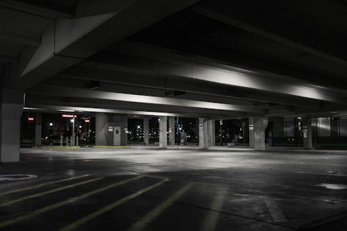 Parking lot at night with proper sealcoating and parking lot striping.