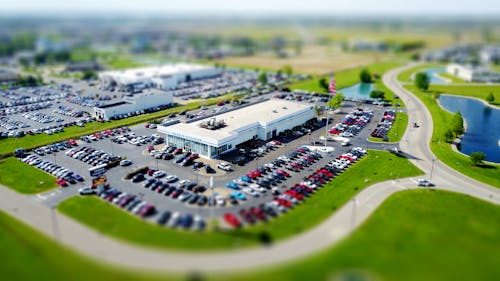 Aerial view of a commercial parking lot with parked cars
