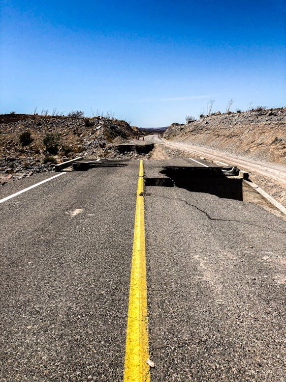 concrete road with yellow solid line