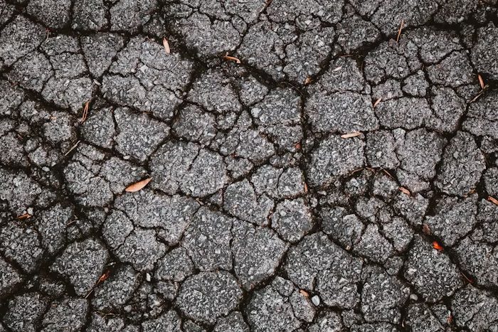 A badly damaged asphalt surface.