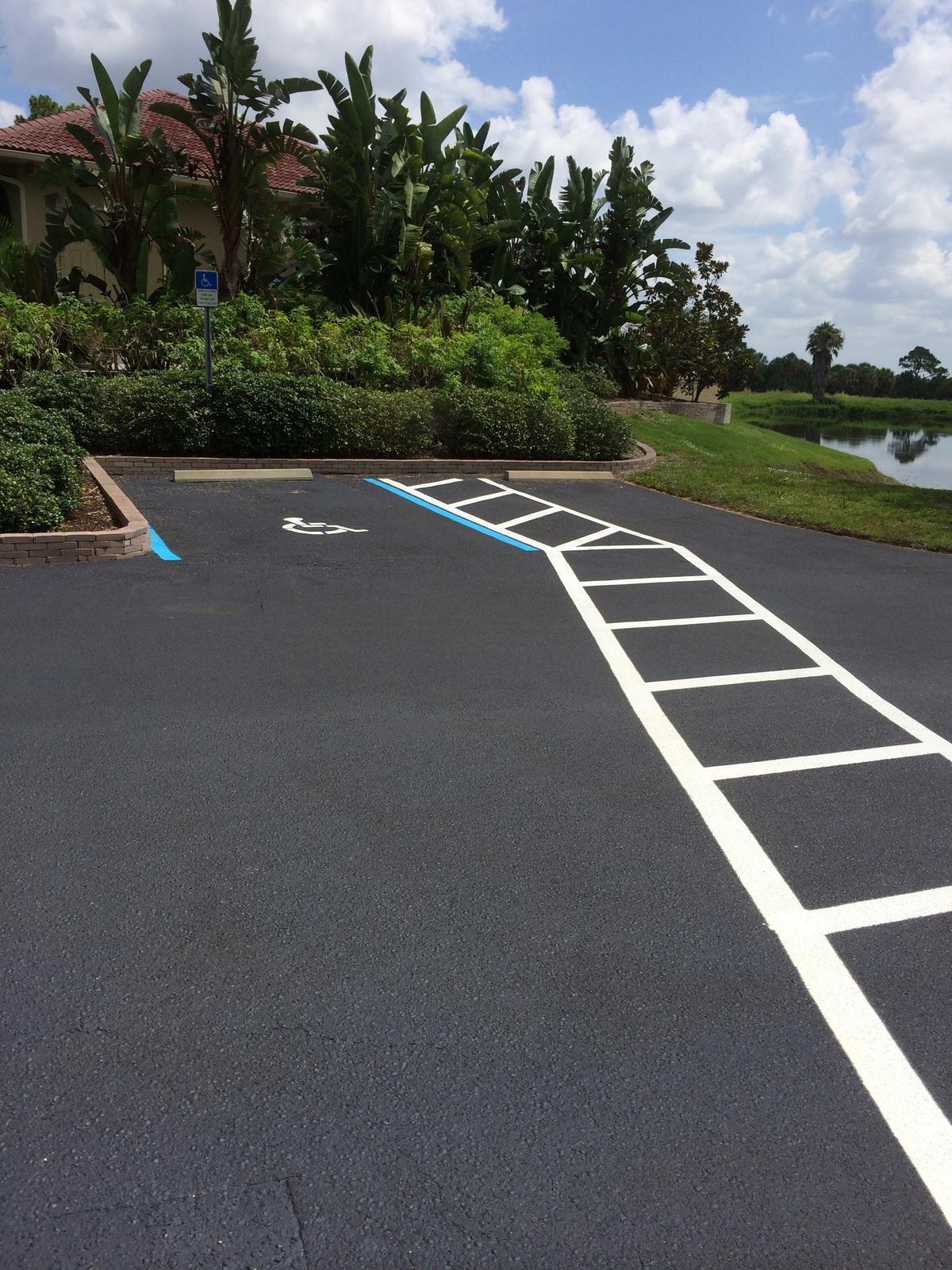 Freshly sealcoated lot with new crosshatching and accessible parking lines